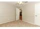 Simple bedroom with neutral carpeting and open view to the kitchen at 102 Carriage Hill Dr, Casselberry, FL 32707