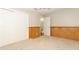 Simple bedroom with wood paneling, neutral carpet, and double doors leading to a closet at 102 Carriage Hill Dr, Casselberry, FL 32707