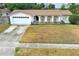 Ranch style home with white garage door and small front yard at 102 Carriage Hill Dr, Casselberry, FL 32707