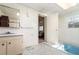 Bathroom with light wood cabinets and blue bathtub at 1074 Gerona Ave, Deltona, FL 32725