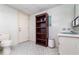 Small bathroom with toilet, sink, and built-in shelving at 1074 Gerona Ave, Deltona, FL 32725