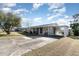 Single story home with carport and mature landscaping at 1074 Gerona Ave, Deltona, FL 32725