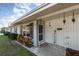 Front entrance with brick facade, welcome sign, and potted plants at 1074 Gerona Ave, Deltona, FL 32725