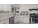 White kitchen with stainless steel appliances and corner sink at 1074 Gerona Ave, Deltona, FL 32725