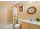 Bright bathroom with a shower/tub combo, vanity, and a floral shower curtain at 1098 Soria Ave, Orlando, FL 32807