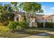 Tan house with brown roof and lush green landscaping at 1098 Soria Ave, Orlando, FL 32807