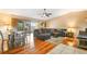 Living room with hardwood floors, sectional sofa, and wood dining table at 1098 Soria Ave, Orlando, FL 32807