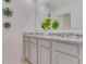 Modern bathroom with granite countertops, double sinks, and gray cabinets at 11363 Amber Ridge Dr, Zellwood, FL 32798