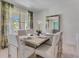 Elegant dining room featuring a large table, modern chairs, and natural light at 11363 Amber Ridge Dr, Zellwood, FL 32798