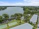 Beautiful aerial view of a lakefront property with a pool and recreational facilities at 1140 S Orlando Ave # J6, Maitland, FL 32751