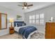 Inviting bedroom featuring a ceiling fan, shutters, and decorative rug at 1140 S Orlando Ave # J6, Maitland, FL 32751