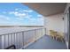 Balcony with table and chairs offering scenic lake views at 13427 Blue Heron Beach Dr # 1001, Orlando, FL 32821