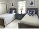 Two twin beds with matching bedding and nightstands at 13427 Blue Heron Beach Dr # 1001, Orlando, FL 32821