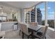 Modern dining area with city view and kitchen access at 13427 Blue Heron Beach Dr # 1001, Orlando, FL 32821