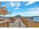 Wooden dock extending over calm lake water with gazebo at 13427 Blue Heron Beach Dr # 1001, Orlando, FL 32821