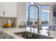 Modern kitchen with a stainless steel sink and lake view at 13427 Blue Heron Beach Dr # 1001, Orlando, FL 32821