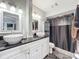 Modern bathroom with dual sinks, granite countertop, and shower at 1350 Winter Green Way, Winter Garden, FL 34787