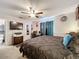 Spacious bedroom with a large bed, dresser, and a workspace at 1350 Winter Green Way, Winter Garden, FL 34787