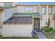 Townhouse exterior featuring a covered entryway and security system at 1350 Winter Green Way, Winter Garden, FL 34787