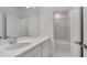 Clean bathroom with white vanity, marble-tiled shower, and bathtub at 1551 Gateway Ln, Kissimmee, FL 34746