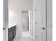 Dark vanity, white walls, and marble tiled floor in bathroom hallway at 1551 Gateway Ln, Kissimmee, FL 34746