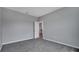 Bright bedroom with gray walls and carpet, offering access to a hallway at 1551 Gateway Ln, Kissimmee, FL 34746