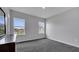 Well-lit bedroom featuring gray carpeting and two large windows at 1551 Gateway Ln, Kissimmee, FL 34746