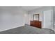 Gray-walled bedroom with dark brown dresser and gray carpeting at 1551 Gateway Ln, Kissimmee, FL 34746