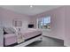 Charming bedroom with pink walls, a queen bed, and plenty of natural light at 1551 Gateway Ln, Kissimmee, FL 34746