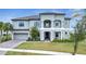 Two-story home with gray exterior, tile roof, and a three-car garage at 1551 Gateway Ln, Kissimmee, FL 34746