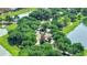 Aerial view of community gated entrance surrounded by lush trees and water at 1551 Gateway Ln, Kissimmee, FL 34746