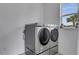 Laundry room with modern washer and dryer, and ample counter space at 1551 Gateway Ln, Kissimmee, FL 34746