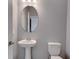 Small powder room with pedestal sink and toilet at 1551 Gateway Ln, Kissimmee, FL 34746