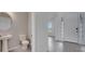 Powder room with pedestal sink, toilet, and tile floors at 1551 Gateway Ln, Kissimmee, FL 34746