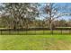 Backyard with pond view and a black metal fence at 1698 Riveredge Rd, Oviedo, FL 32766