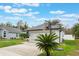 Gray house with a basketball hoop and palm tree at 1698 Riveredge Rd, Oviedo, FL 32766