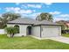 Gray house with a two-car garage and well-manicured lawn at 1698 Riveredge Rd, Oviedo, FL 32766