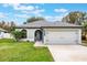 Gray house with a two-car garage and well-manicured lawn at 1698 Riveredge Rd, Oviedo, FL 32766