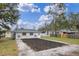 House with backyard, shed, and gravel parking area at 1703 E Fern Rd, Lakeland, FL 33801