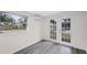 Bedroom with grey flooring and French doors to backyard at 1703 E Fern Rd, Lakeland, FL 33801