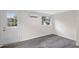 Simple bedroom with grey flooring and exterior access at 1703 E Fern Rd, Lakeland, FL 33801