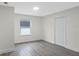 Simple bedroom with grey flooring and closet at 1703 E Fern Rd, Lakeland, FL 33801