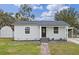 Newly renovated house with gray exterior, walkway, and a small shed at 1703 E Fern Rd, Lakeland, FL 33801