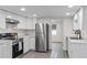 Modern kitchen with stainless steel appliances and white cabinets at 1703 E Fern Rd, Lakeland, FL 33801