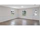 Bright living room with gray vinyl flooring and white wainscoting at 1703 E Fern Rd, Lakeland, FL 33801