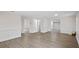 Spacious living room with gray vinyl flooring and white wainscoting at 1703 E Fern Rd, Lakeland, FL 33801