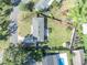 An aerial view showcasing a single-story home, expansive lawn, and a swimming pool at 2127 Lake Dr, Winter Park, FL 32789