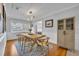 Light and airy dining room with a rustic wooden table, hardwood floors, and built-in storage at 2127 Lake Dr, Winter Park, FL 32789