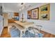 Bright dining room features a rustic farmhouse table with bench seating, hardwood floors, and kitchen views at 2127 Lake Dr, Winter Park, FL 32789