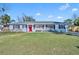 Charming ranch home with red door, brick facade, and spacious lawn at 2127 Lake Dr, Winter Park, FL 32789